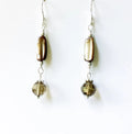 Pair of earrings with brown and clear beads on a white background