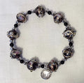 Bracelet with decorative beads on a light gray background