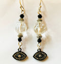 Pair of earrings with black and gold accents on a white background