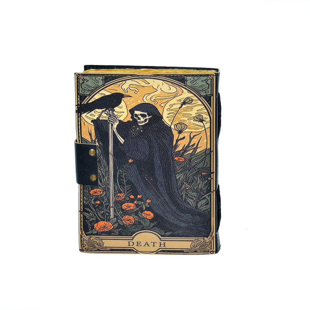 Book with a design of a skeleton holding a skull, surrounded by flowers, on a white background.